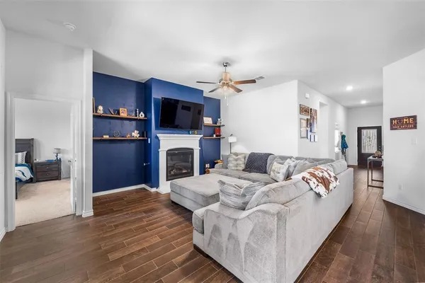 a living room with furniture fireplace and flat screen tv