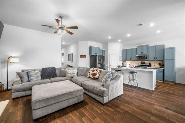 a living room with furniture and kitchen view