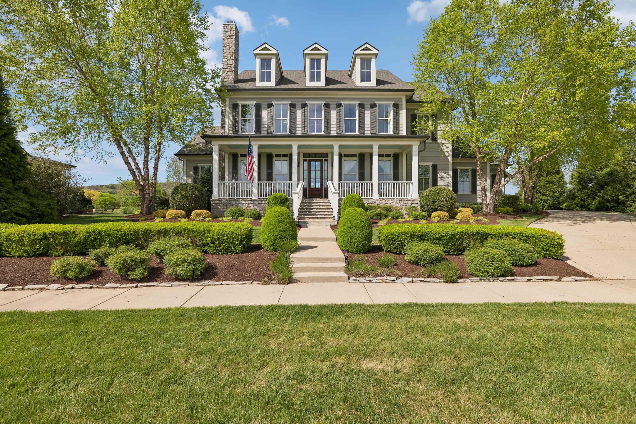 6033 Native Pony Trail College Grove, TN 37046 - Photo 1 of 87 a front view of a house with a garden