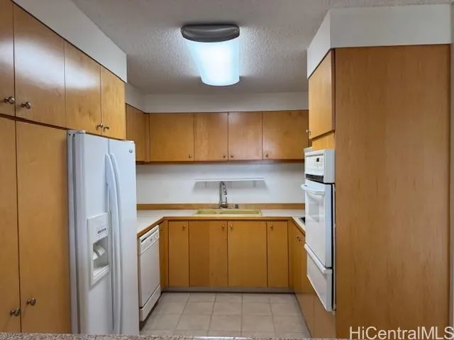 a kitchen with a refrigerator and a sink