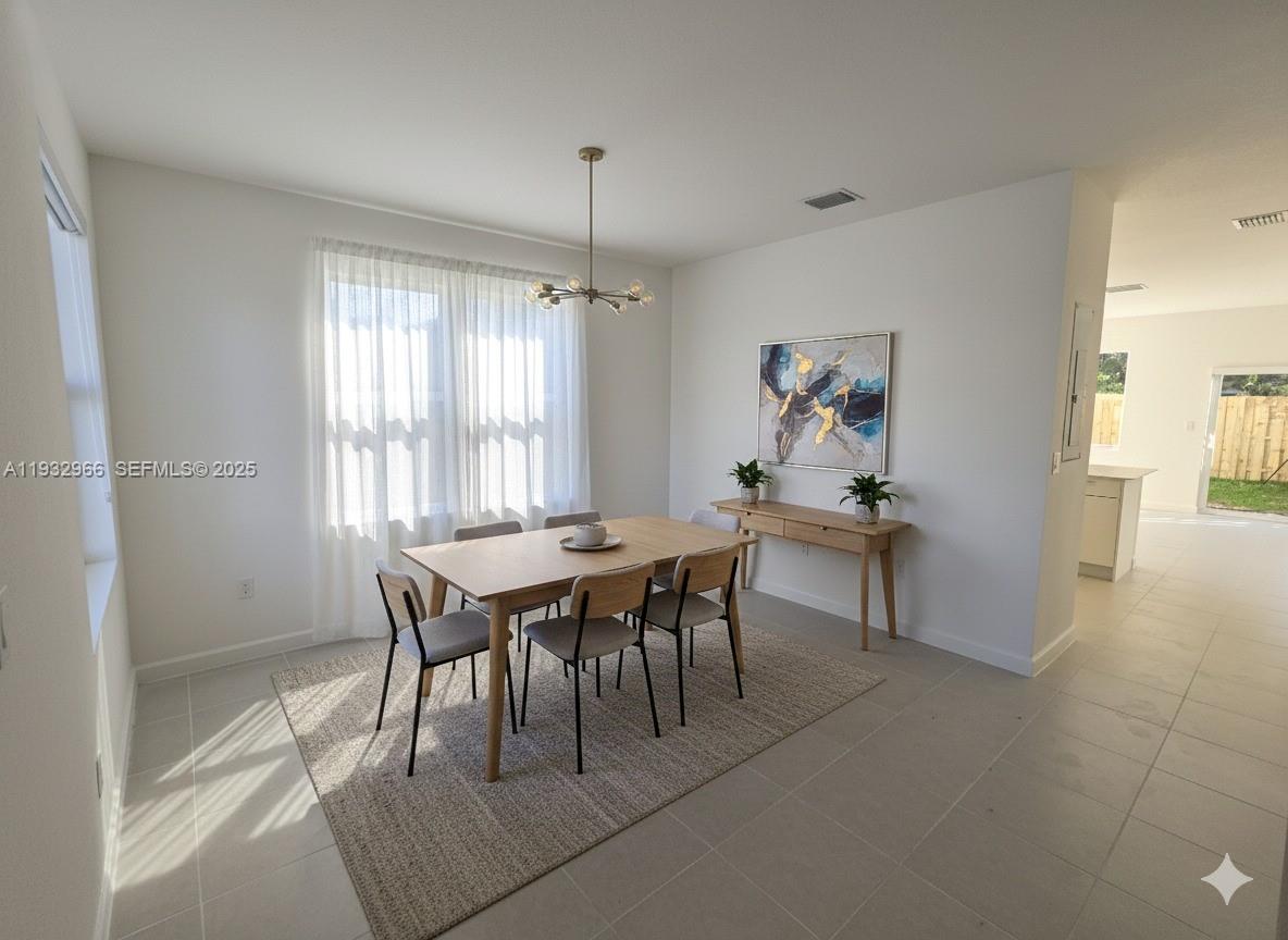12136 Southwest 268th Street Homestead, FL 33032 - Photo 2 of 11 a view of a dining room with furniture and window