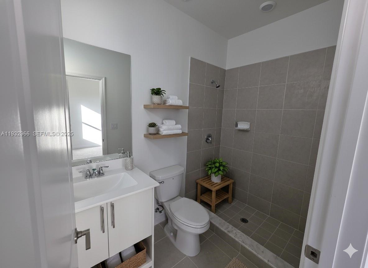12136 Southwest 268th Street Homestead, FL 33032 - Photo 3 of 11 a white toilet sitting next to a bathroom sink