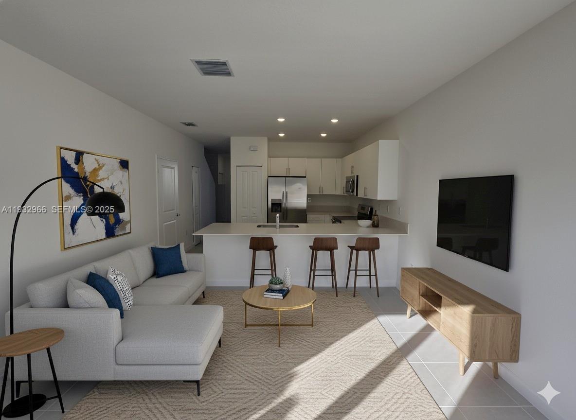 12136 Southwest 268th Street Homestead, FL 33032 - Photo 5 of 11 a living room with furniture and a flat screen tv