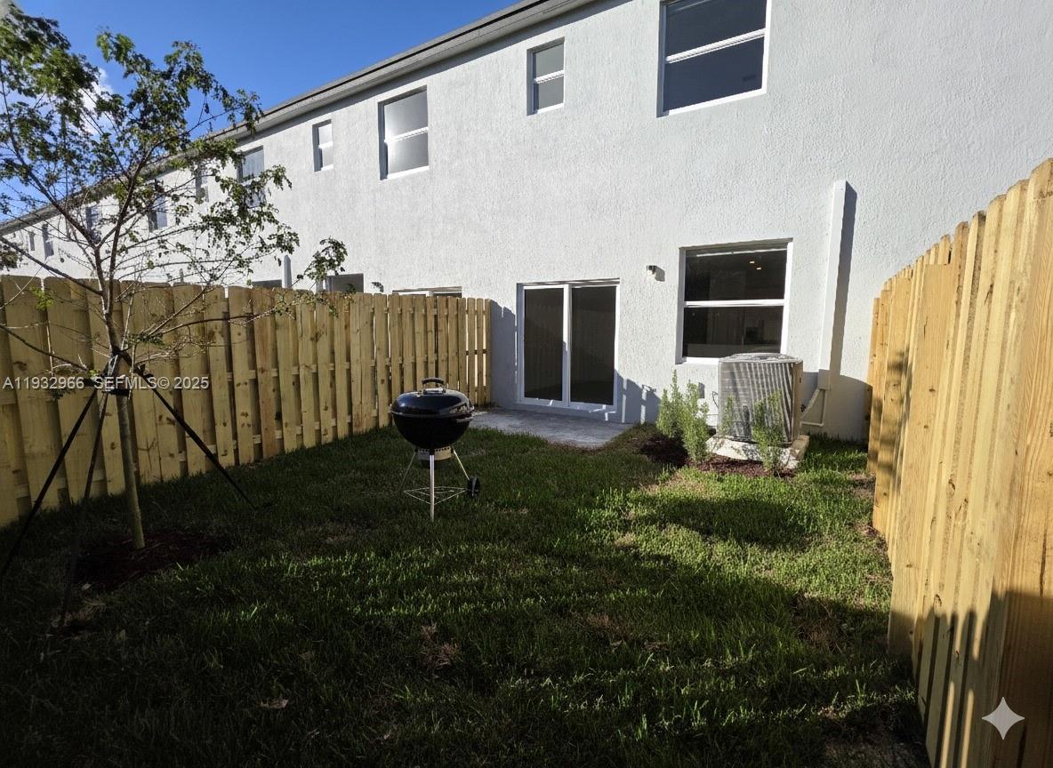 12136 Southwest 268th Street Homestead, FL 33032 - Photo 7 of 11 a backyard of a house with seating space