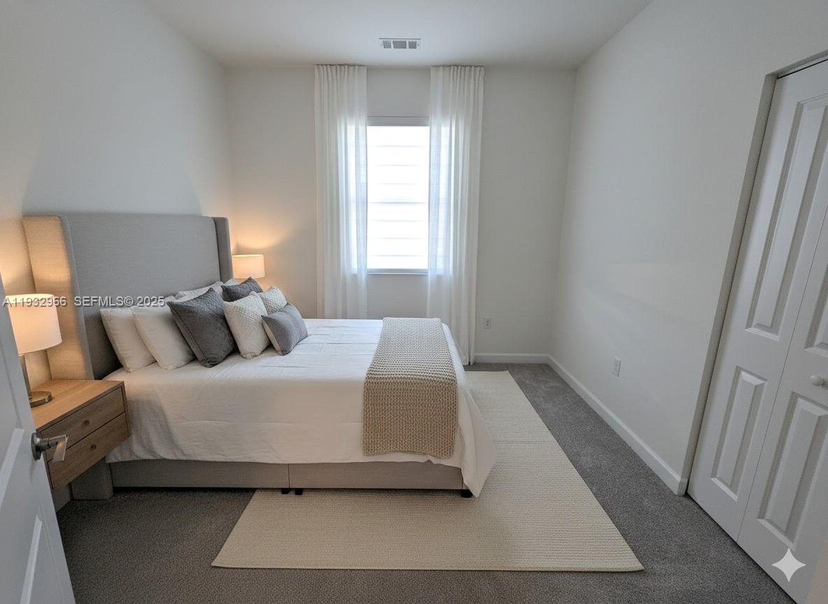12136 Southwest 268th Street Homestead, FL 33032 - Photo 9 of 11 a bedroom with a bed and a window