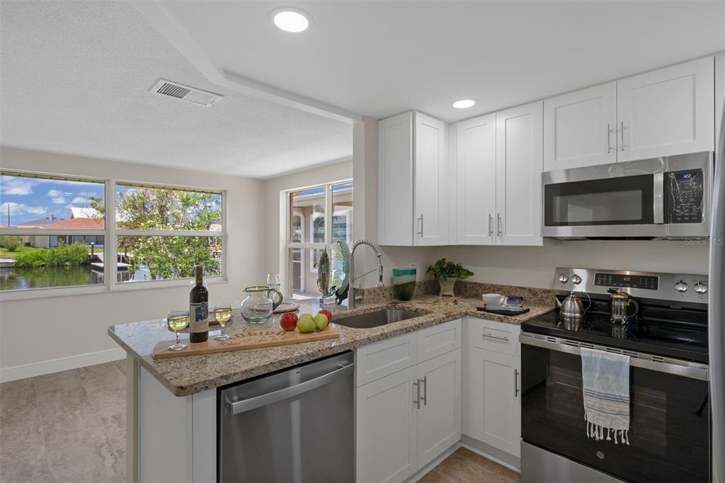 4937 Dory Drive New Port Richey, FL 34652 - Photo 20 of 68 a kitchen with a sink stove and microwave
