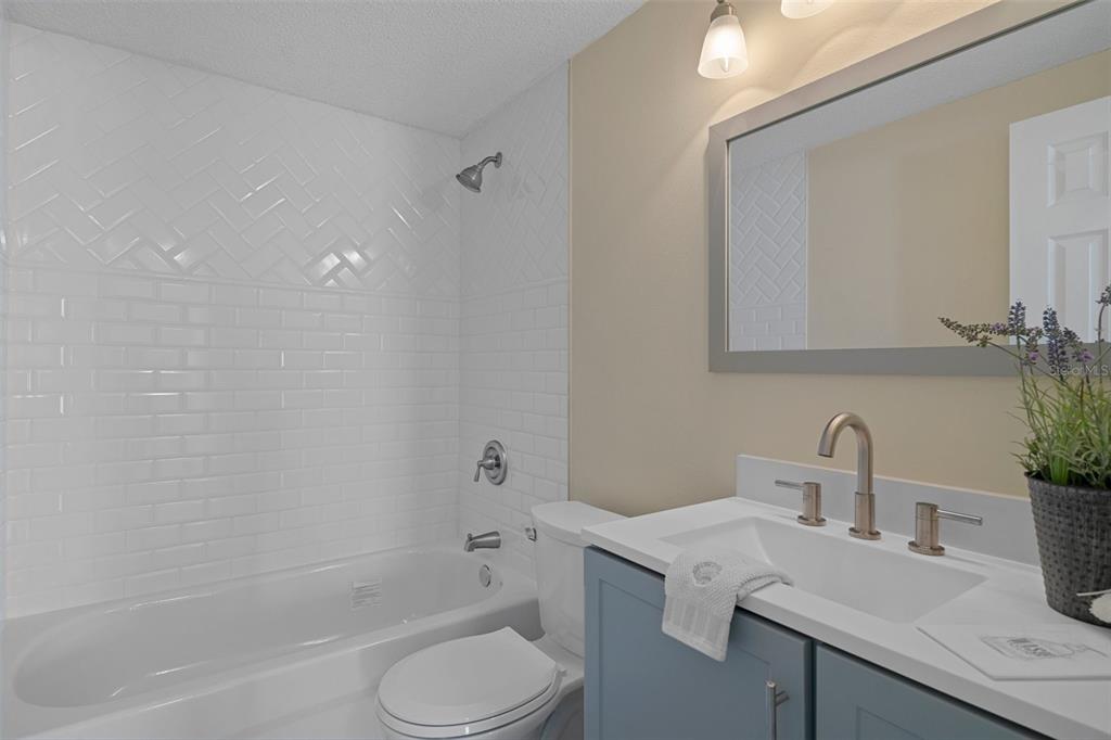 4937 Dory Drive New Port Richey, FL 34652 - Photo 28 of 68 a bathroom with a sink a toilet and shower