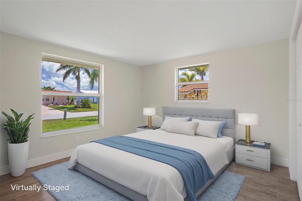 4937 Dory Drive New Port Richey, FL 34652 - Photo 30 of 68 a bedroom with a bed and a painting on the wall