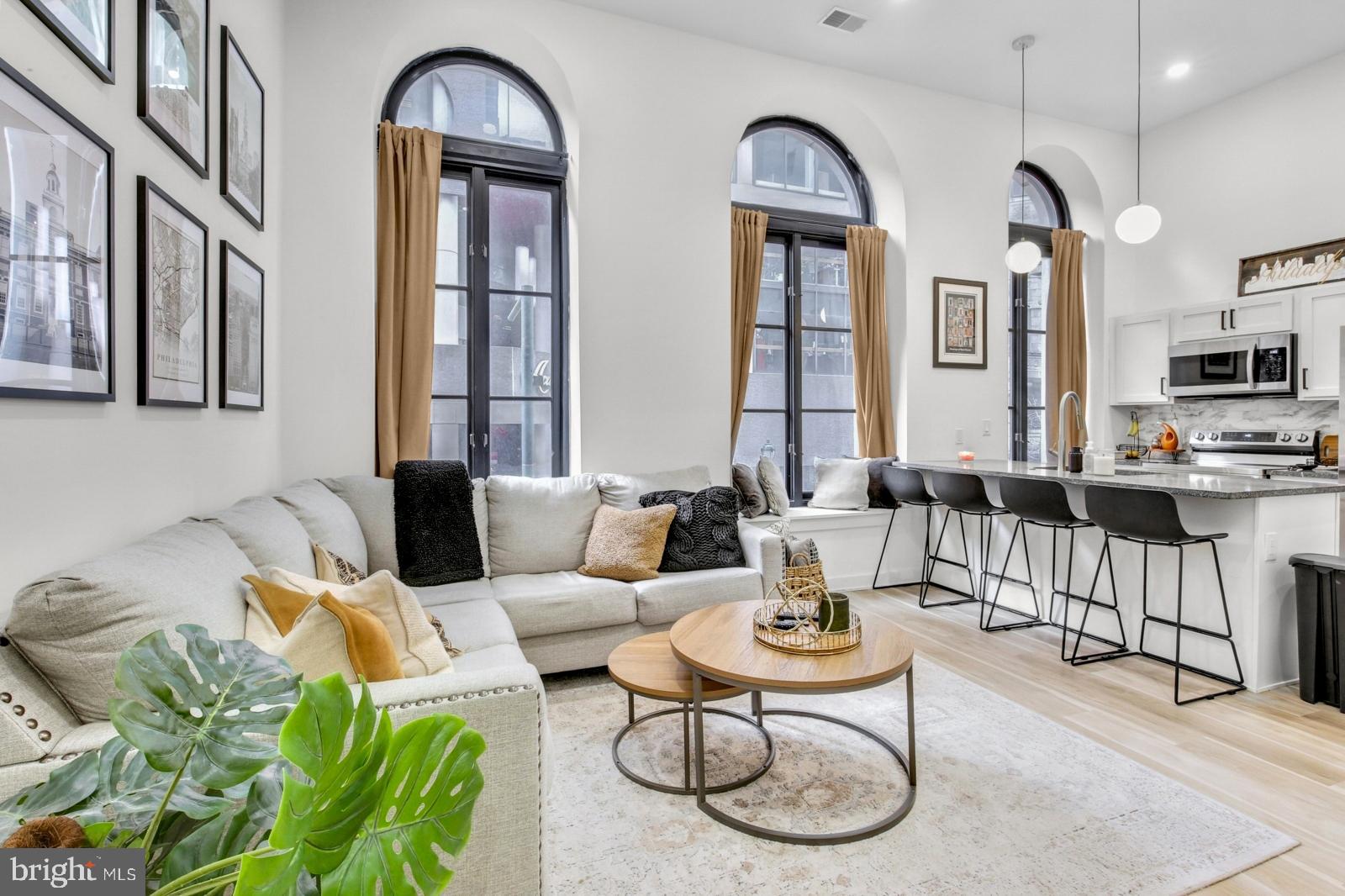 a living room with furniture a couch and a dining table