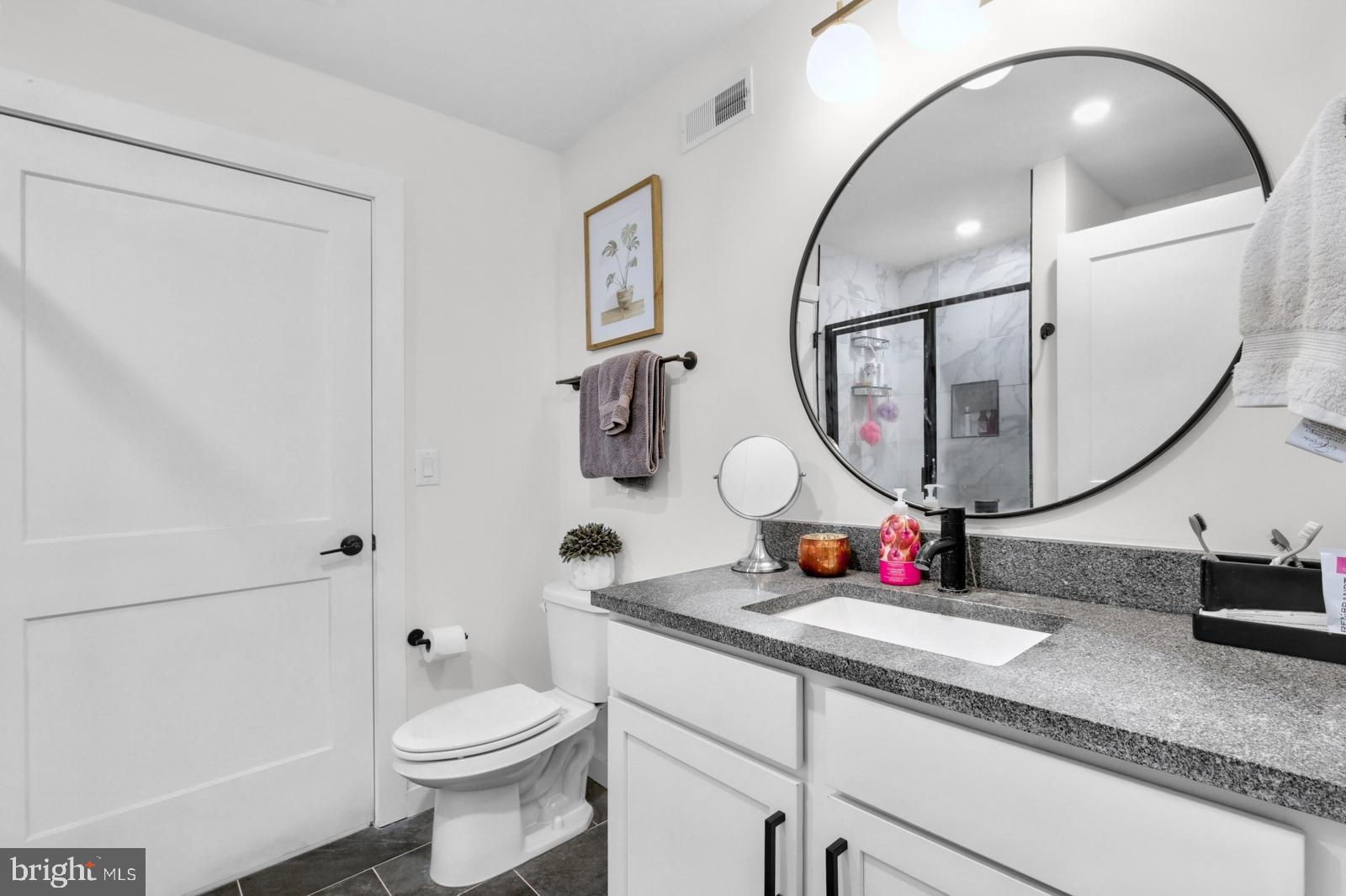 1415 Locust Street, Unit 201 Philadelphia, PA 19102 - Photo 11 of 20 a bathroom with a toilet sink and mirror