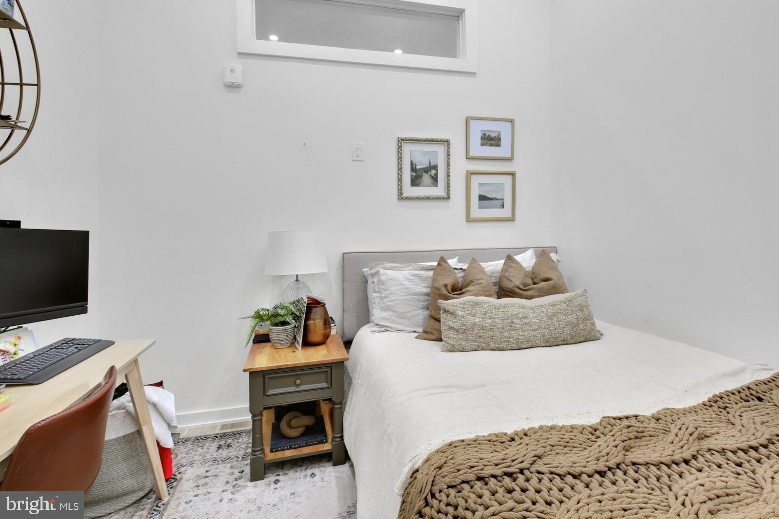 1415 Locust Street, Unit 201 Philadelphia, PA 19102 - Photo 14 of 20 a bedroom with a bed and a flat screen tv