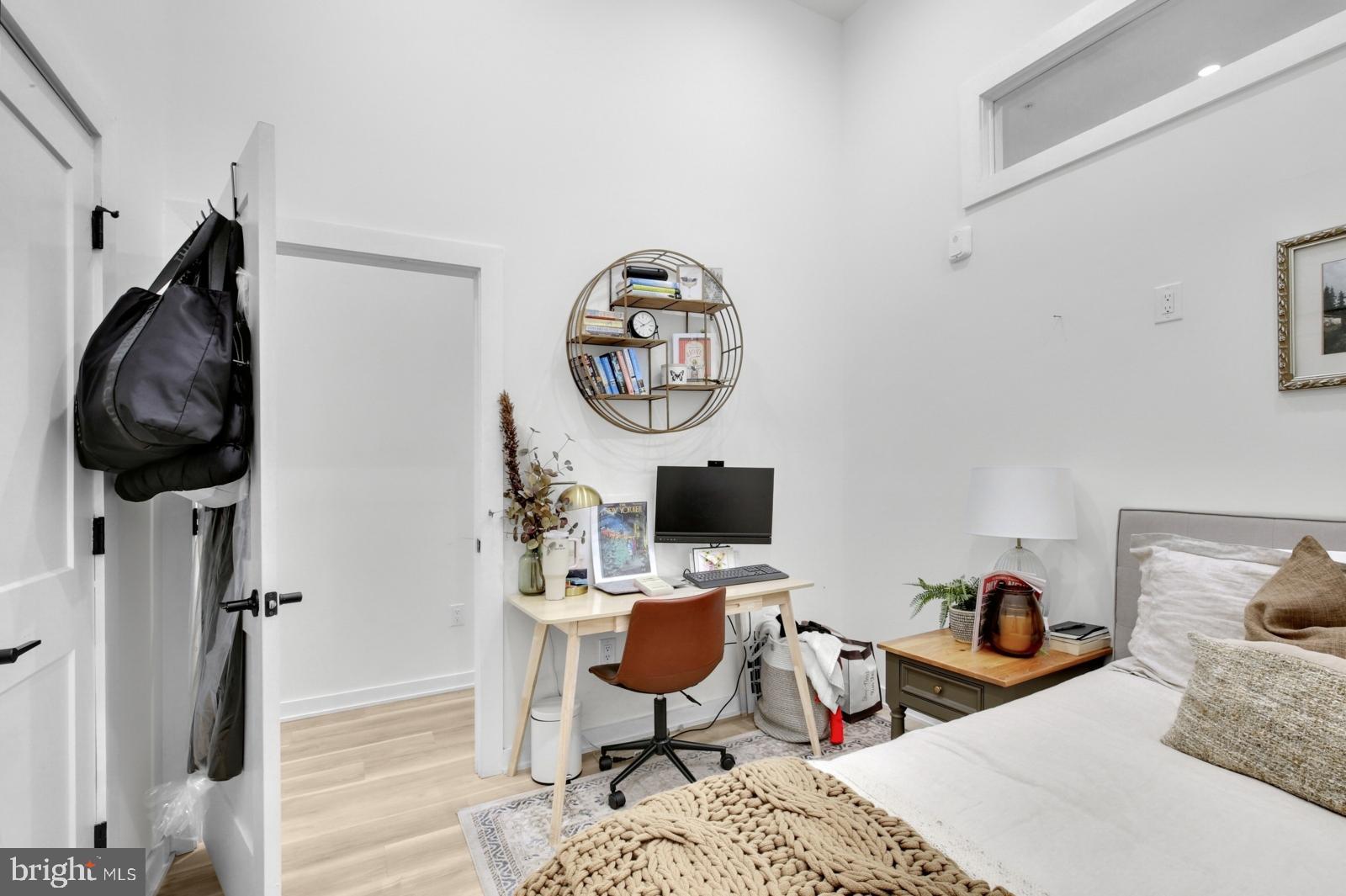 1415 Locust Street, Unit 201 Philadelphia, PA 19102 - Photo 15 of 20 a bedroom with a bed workspace and a mirror