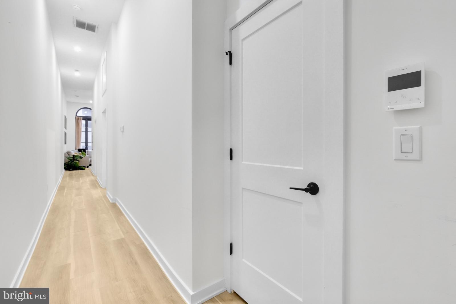 1415 Locust Street, Unit 201 Philadelphia, PA 19102 - Photo 16 of 20 a view of a hallway with wooden floor and staircase