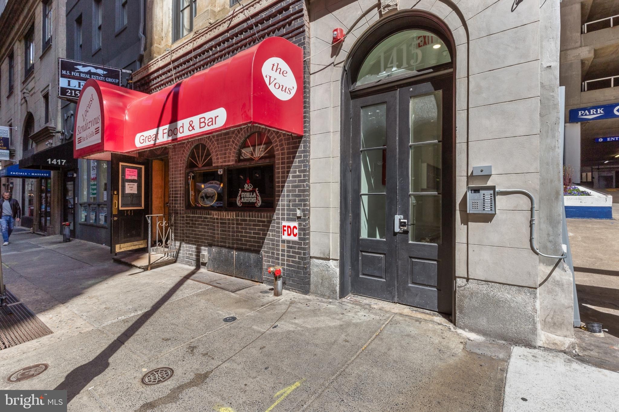 1415 Locust Street, Unit 201 Philadelphia, PA 19102 - Photo 18 of 20 a view of a brick building with a red door and a outdoor space