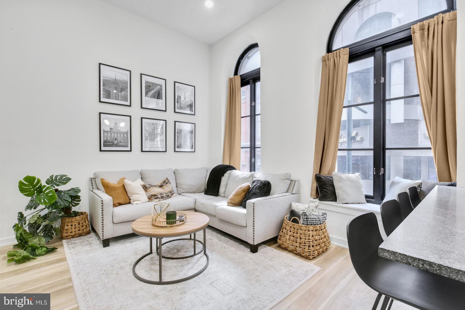 1415 Locust Street, Unit 201 Philadelphia, PA 19102 - Photo 2 of 20 a living room with furniture and a large window