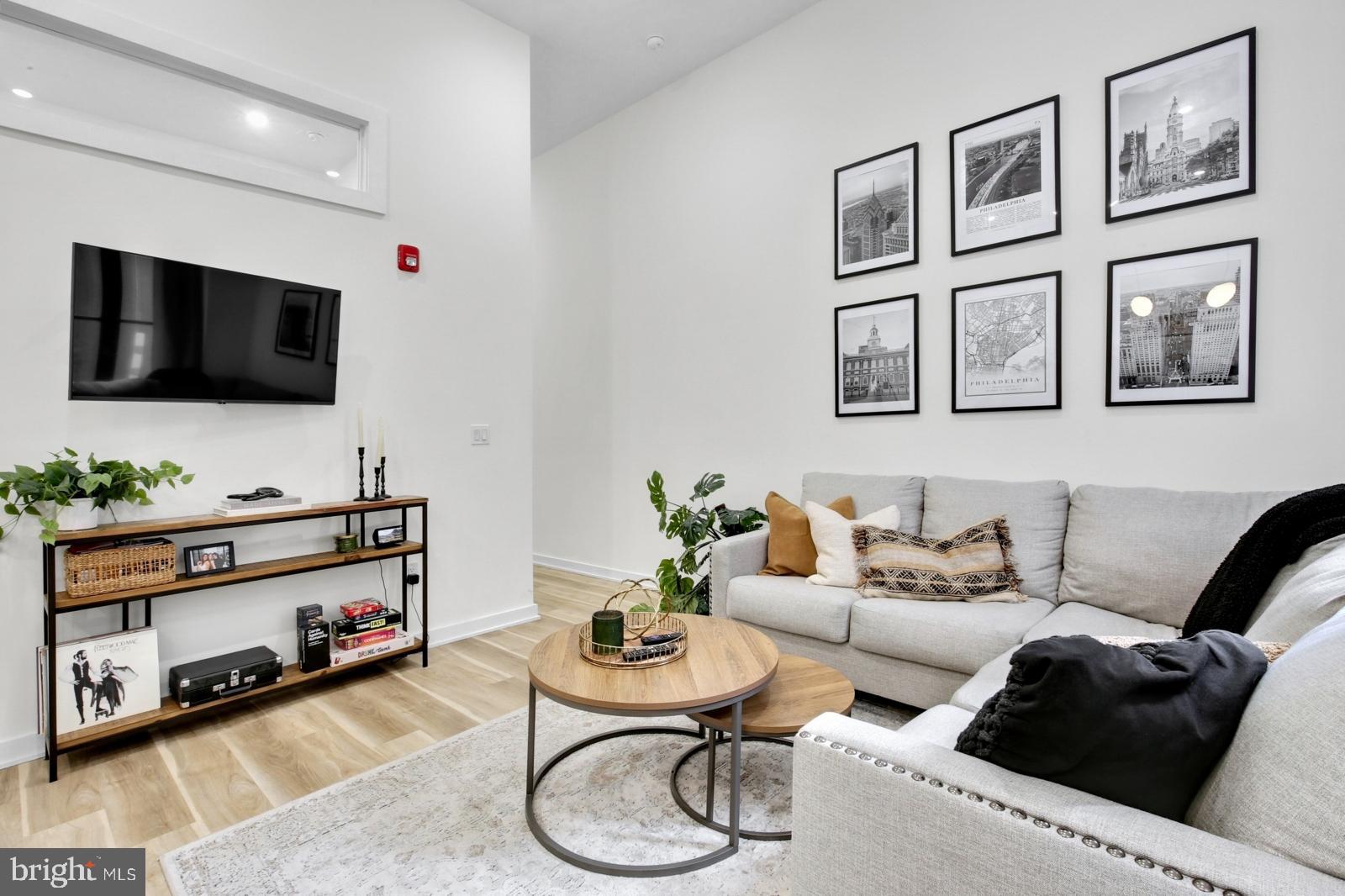 1415 Locust Street, Unit 201 Philadelphia, PA 19102 - Photo 3 of 20 a living room with furniture and a flat screen tv