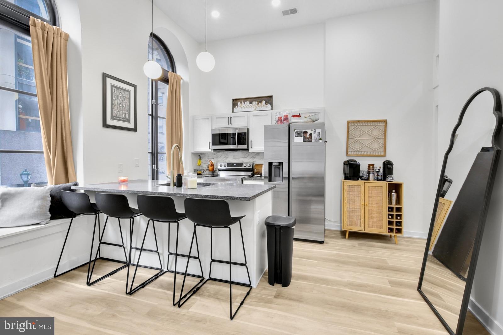 1415 Locust Street, Unit 201 Philadelphia, PA 19102 - Photo 4 of 20 a living room with furniture and a flat screen tv