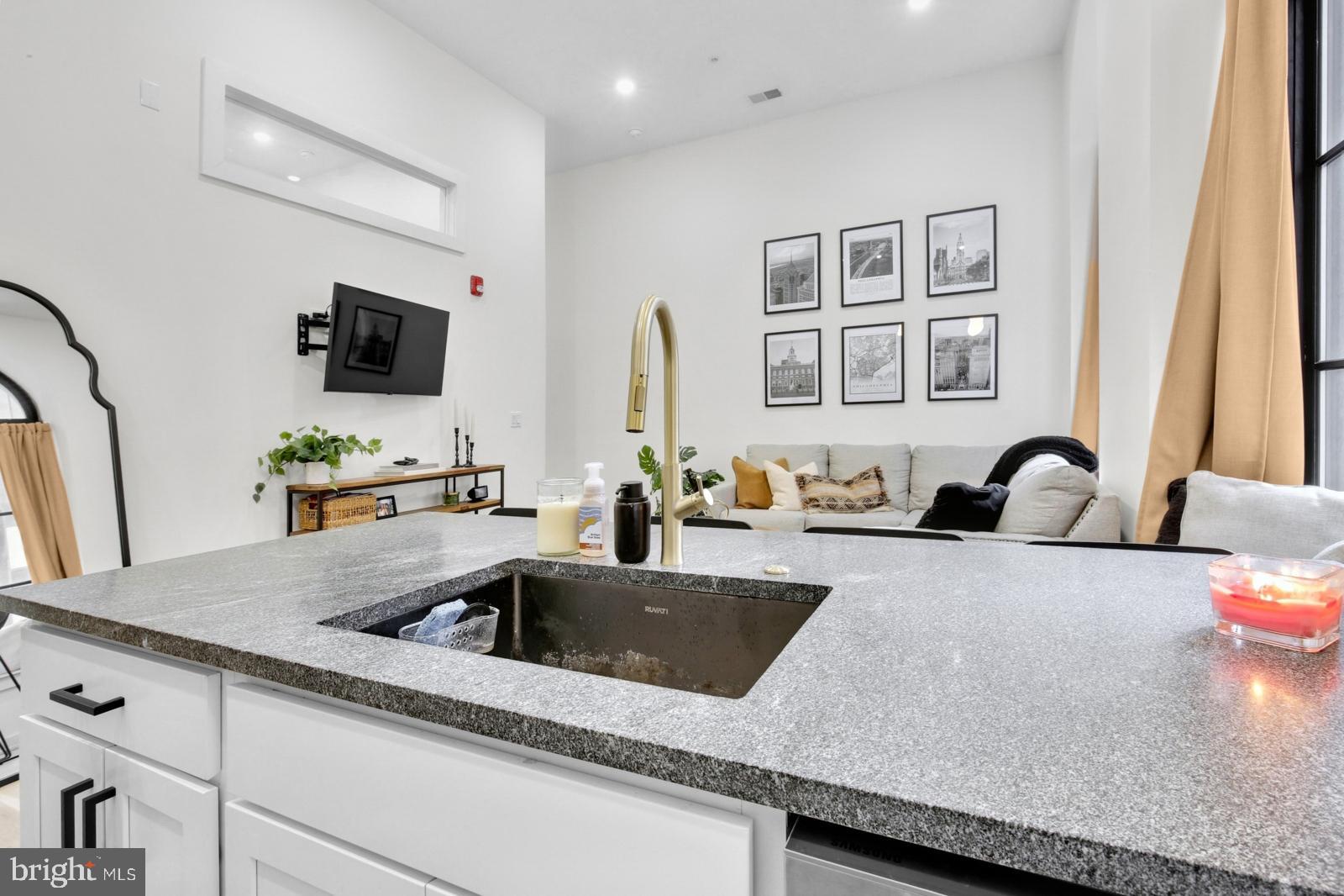 1415 Locust Street, Unit 201 Philadelphia, PA 19102 - Photo 7 of 20 a kitchen with a sink a microwave and cabinets