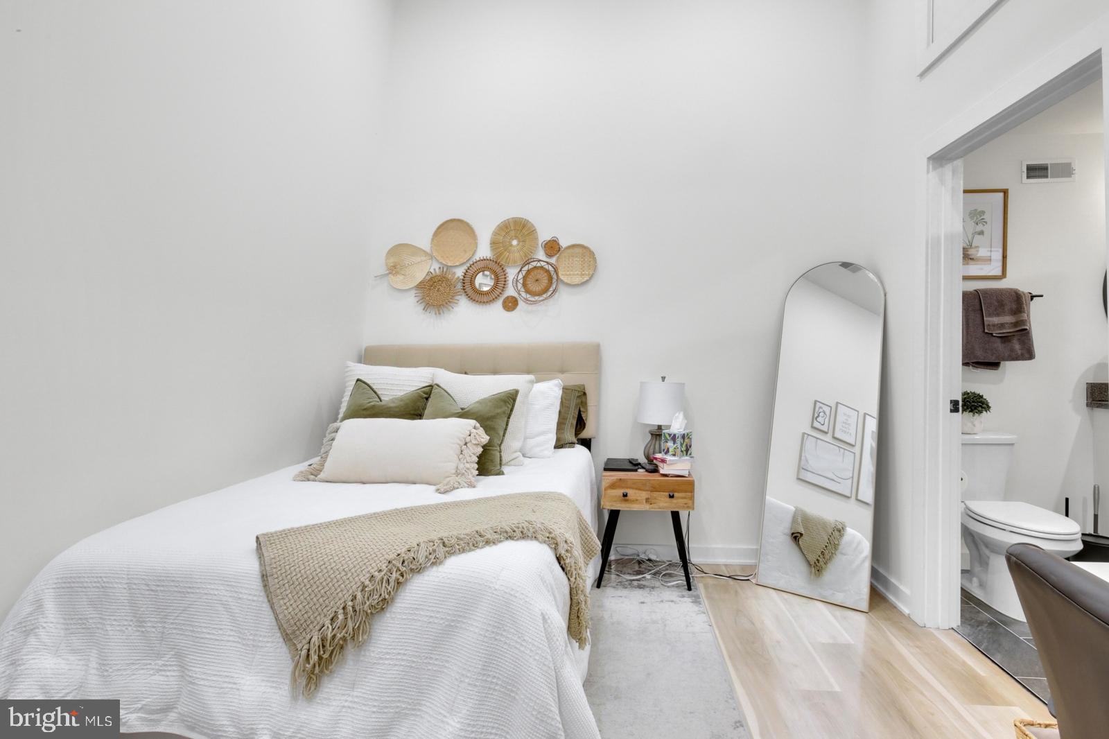 1415 Locust Street, Unit 201 Philadelphia, PA 19102 - Photo 9 of 20 a bedroom with a bed and a mirror