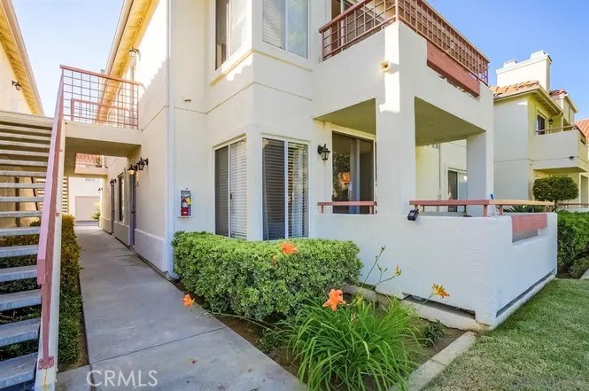445 Ribbon Beach Way, Unit 278 Oceanside, CA 92058 - Photo 14 of 19 a view of a white house with many windows and yard