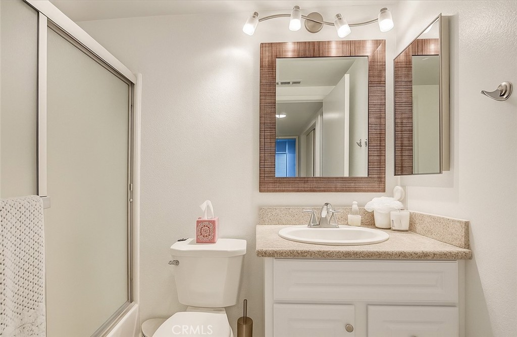 445 Ribbon Beach Way, Unit 278 Oceanside, CA 92058 - Photo 9 of 19 a bathroom with a granite countertop sink mirror and a toilet