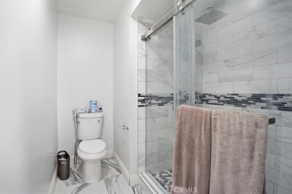 14325 Foothill Boulevard, Unit 9 Sylmar, CA 91342 - Photo 23 of 43 a bathroom with a toilet and shower