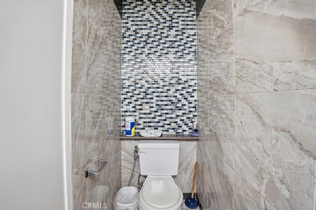 14325 Foothill Boulevard, Unit 9 Sylmar, CA 91342 - Photo 27 of 43 a bathroom with a toilet and a shower curtain