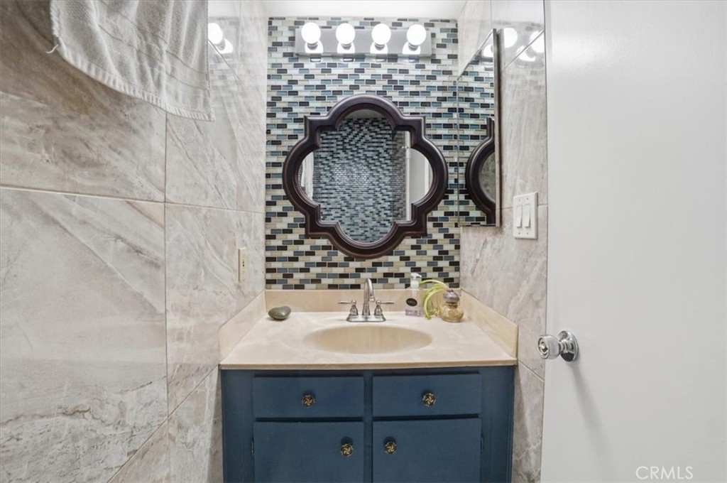 14325 Foothill Boulevard, Unit 9 Sylmar, CA 91342 - Photo 28 of 43 a bathroom with a sink and a mirror