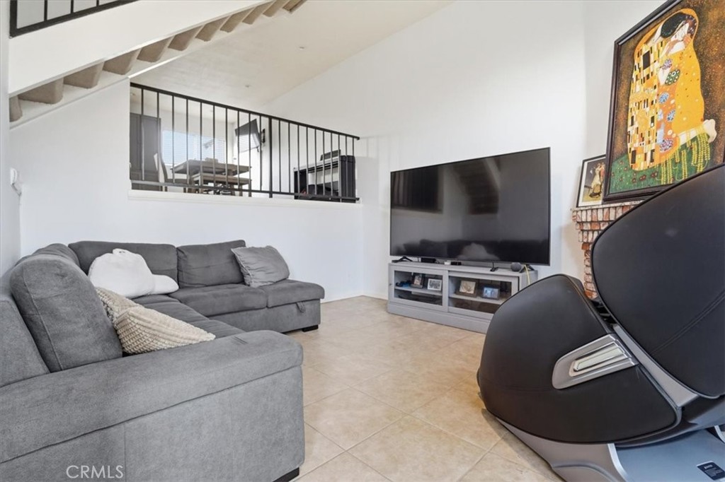 14325 Foothill Boulevard, Unit 9 Sylmar, CA 91342 - Photo 3 of 43 a living room with furniture and a flat screen tv