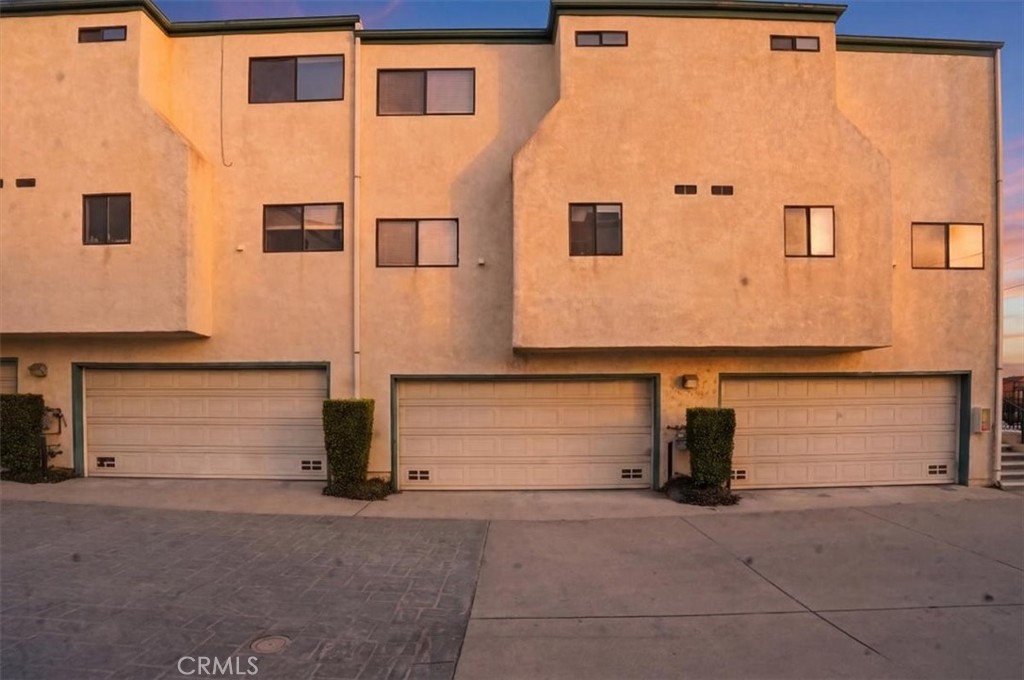 14325 Foothill Boulevard, Unit 9 Sylmar, CA 91342 - Photo 33 of 43 a front view of a house with a garage