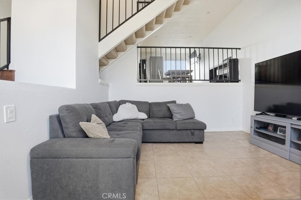 14325 Foothill Boulevard, Unit 9 Sylmar, CA 91342 - Photo 4 of 43 a living room with furniture and a flat screen tv