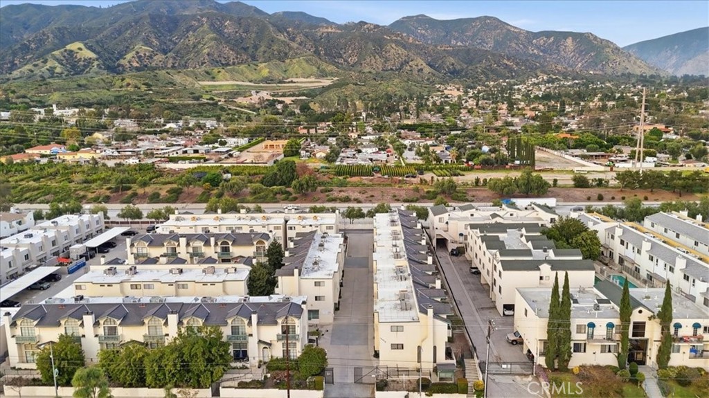 14325 Foothill Boulevard, Unit 9 Sylmar, CA 91342 - Photo 43 of 43 an aerial view of residential building with parking and mountain view