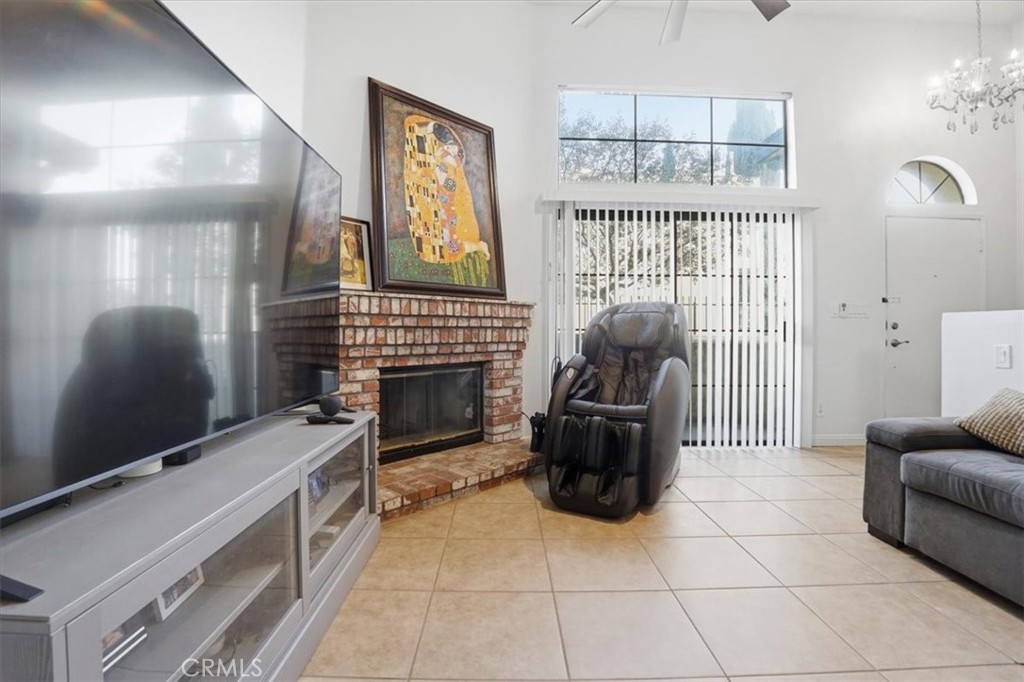 14325 Foothill Boulevard, Unit 9 Sylmar, CA 91342 - Photo 5 of 43 a living room with furniture a fireplace and a flat screen tv