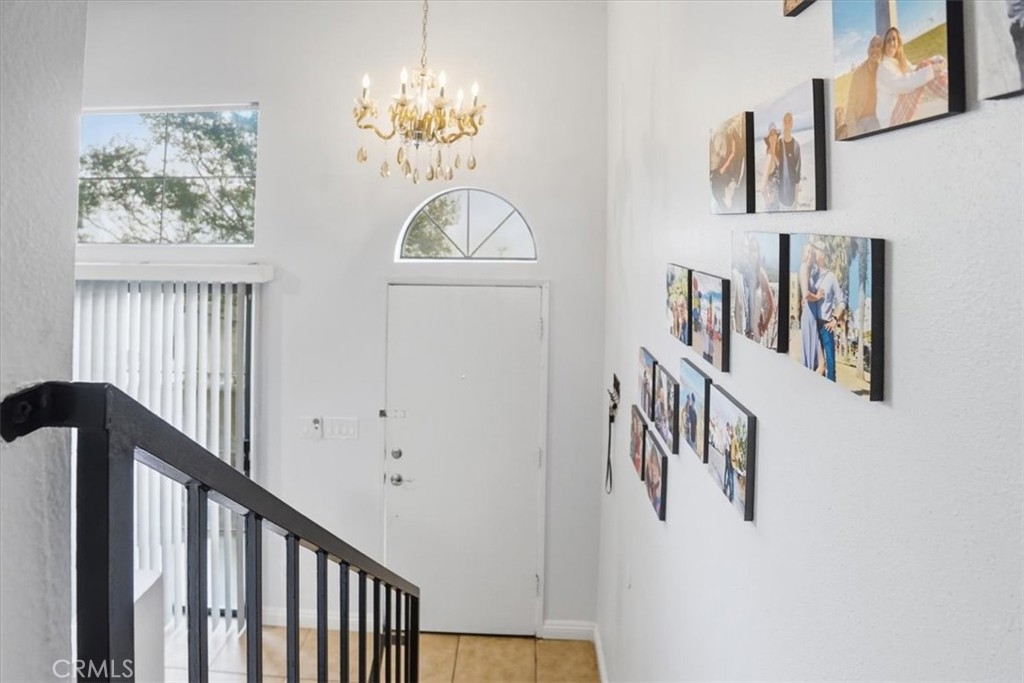 14325 Foothill Boulevard, Unit 9 Sylmar, CA 91342 - Photo 7 of 43 a view of a hallway with windows and chandelier