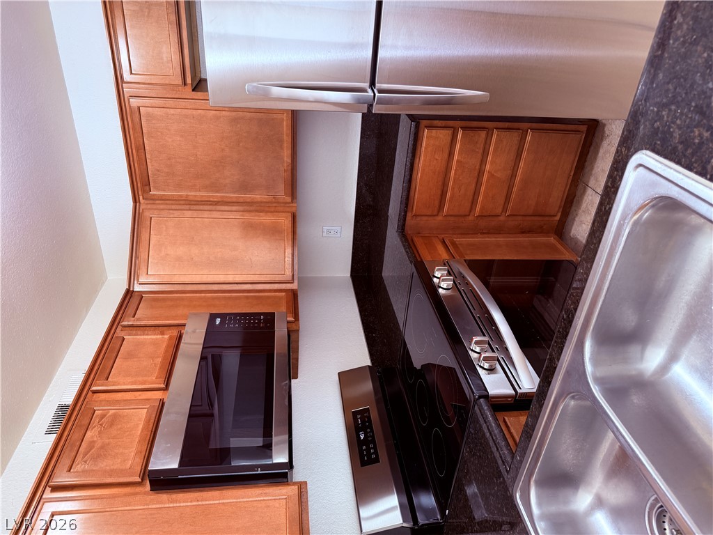 9325 West Desert Inn Road, Unit 260 Las Vegas, NV 89117 - Photo 8 of 42 Culinary delights await in this modern kitchen with granite counters and stainless steel appliances.