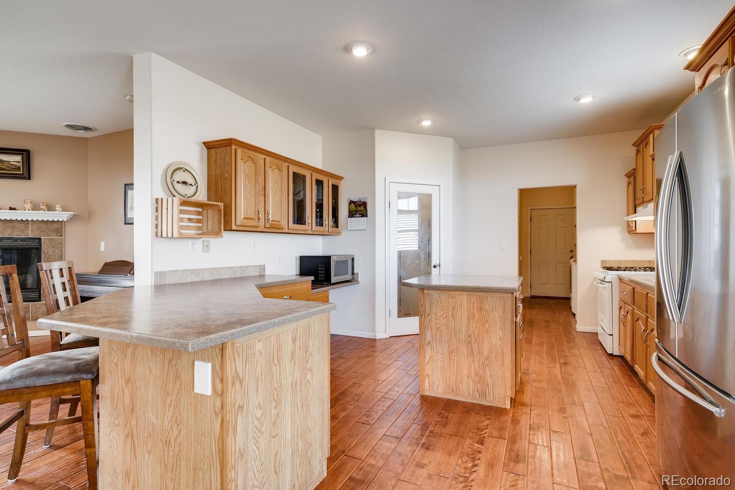 14750 Berridge Road Ramah, CO 80832 - Photo 9 of 40 a living room with stainless steel appliances granite countertop furniture wooden floor and a kitchen view