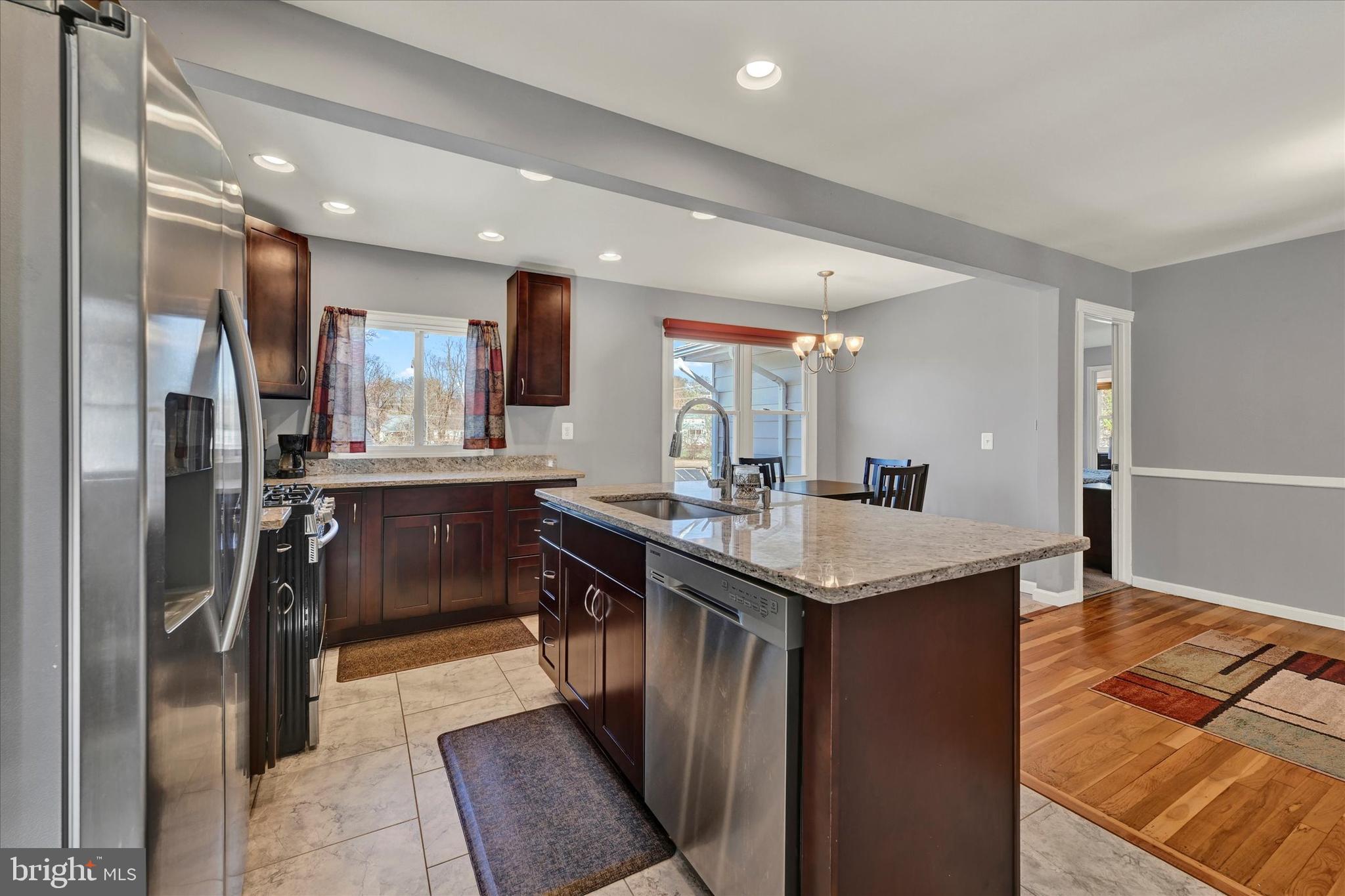 9630 10th Avenue Baltimore, MD 21234 - Photo 12 of 35 a kitchen with stainless steel appliances granite countertop a sink a stove and a refrigerator