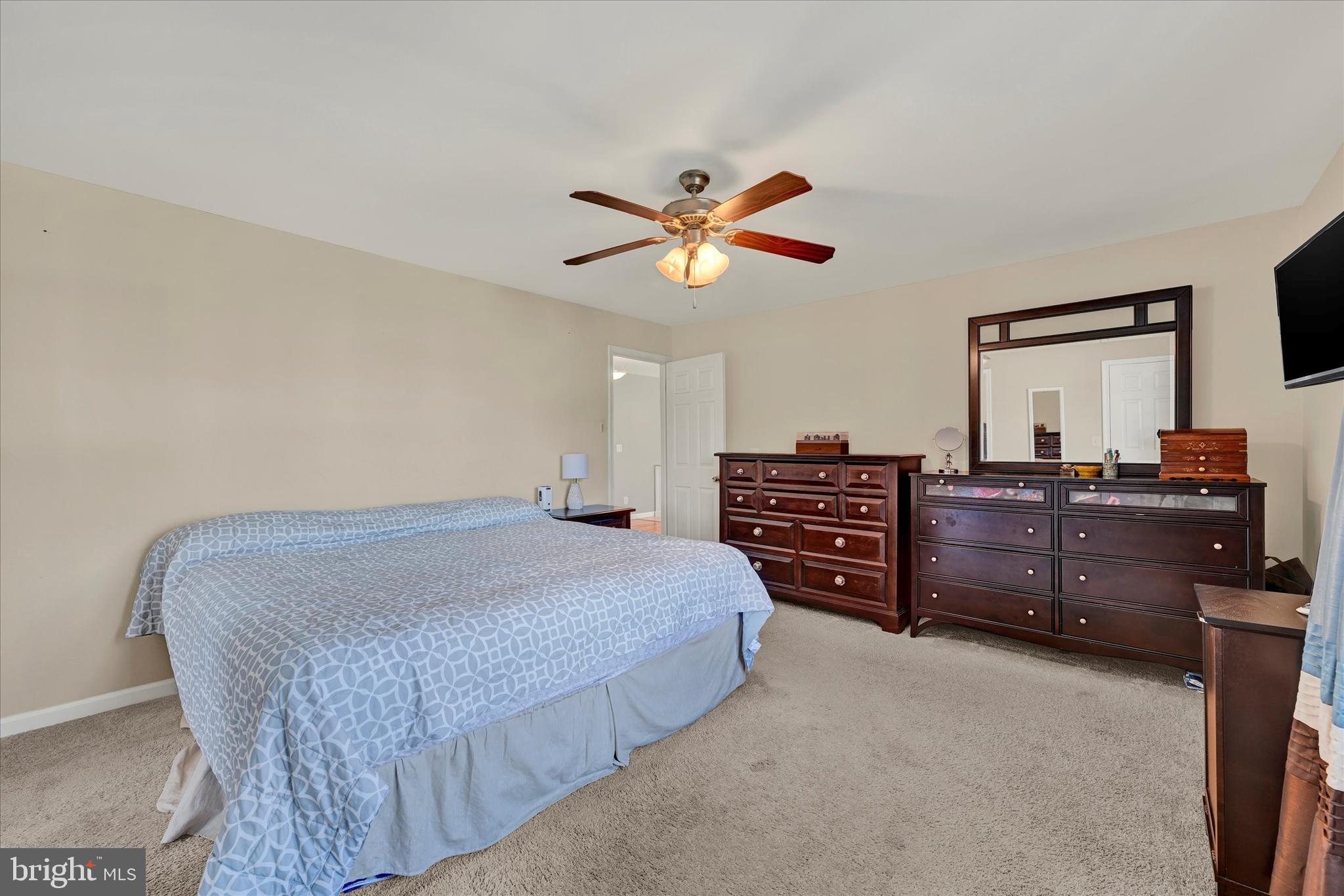 9630 10th Avenue Baltimore, MD 21234 - Photo 16 of 35 a bedroom with a bed dresser and a baby crib