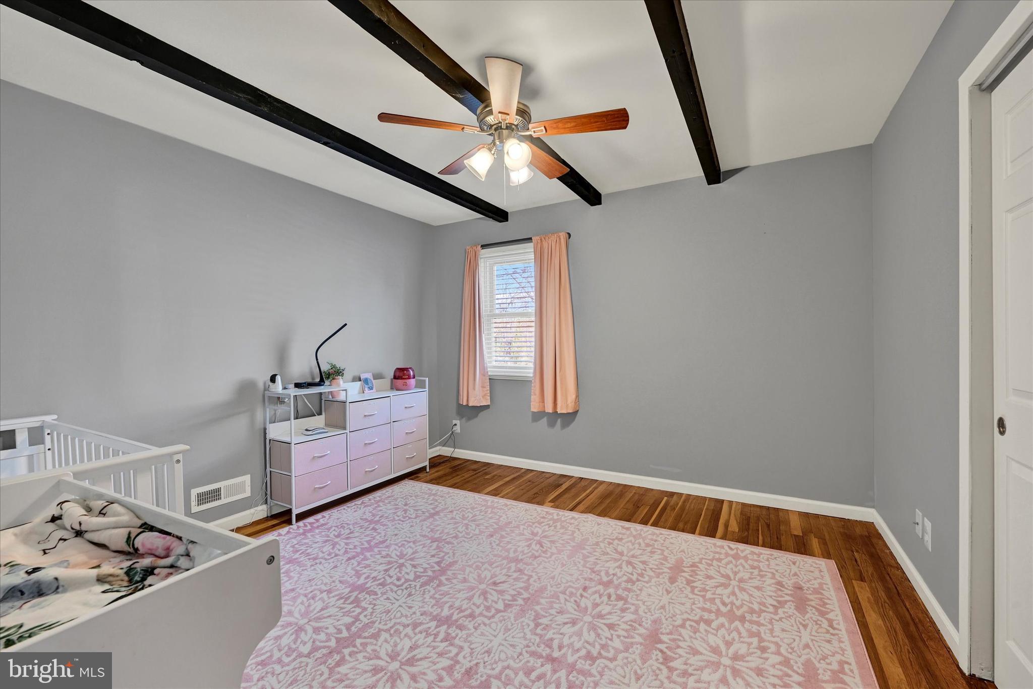 9630 10th Avenue Baltimore, MD 21234 - Photo 18 of 35 a bed room with a bed and a window