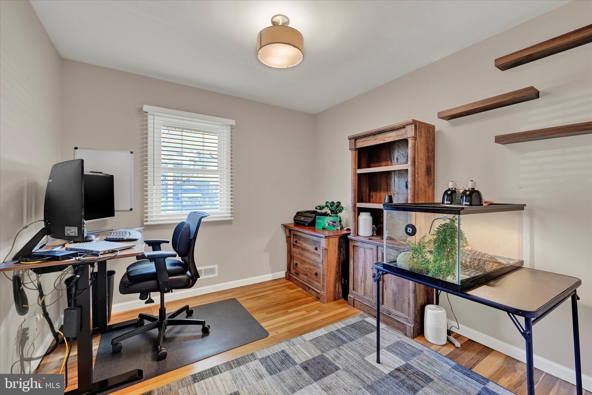 9630 10th Avenue Baltimore, MD 21234 - Photo 20 of 35 a view of a workspace with furniture and a window