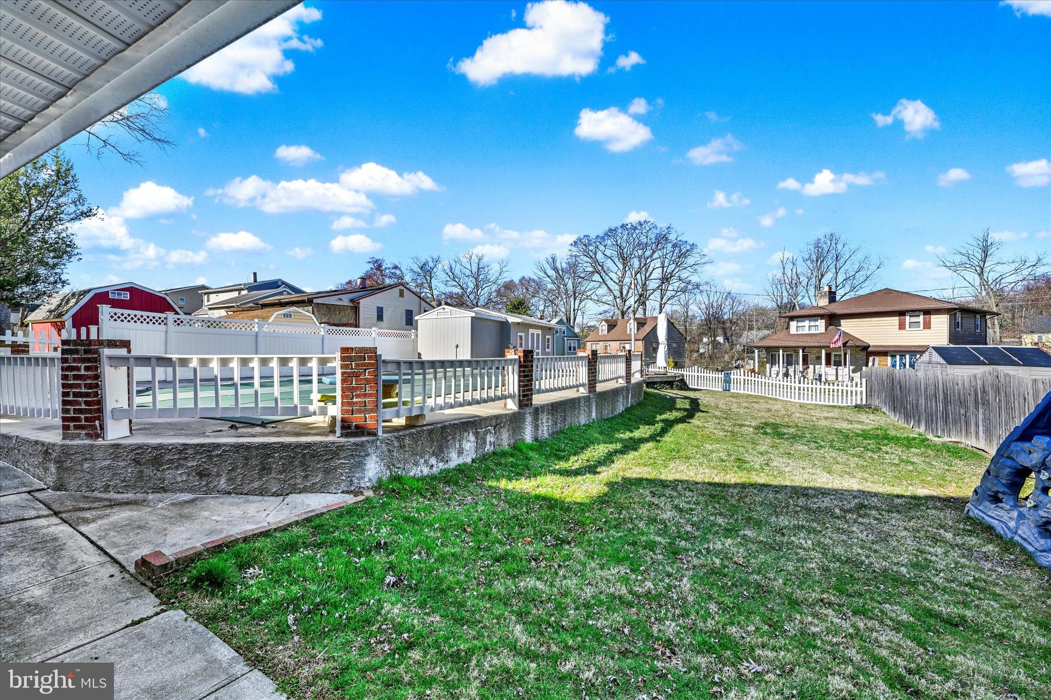 9630 10th Avenue Baltimore, MD 21234 - Photo 28 of 35 a view of a yard with a house in the background