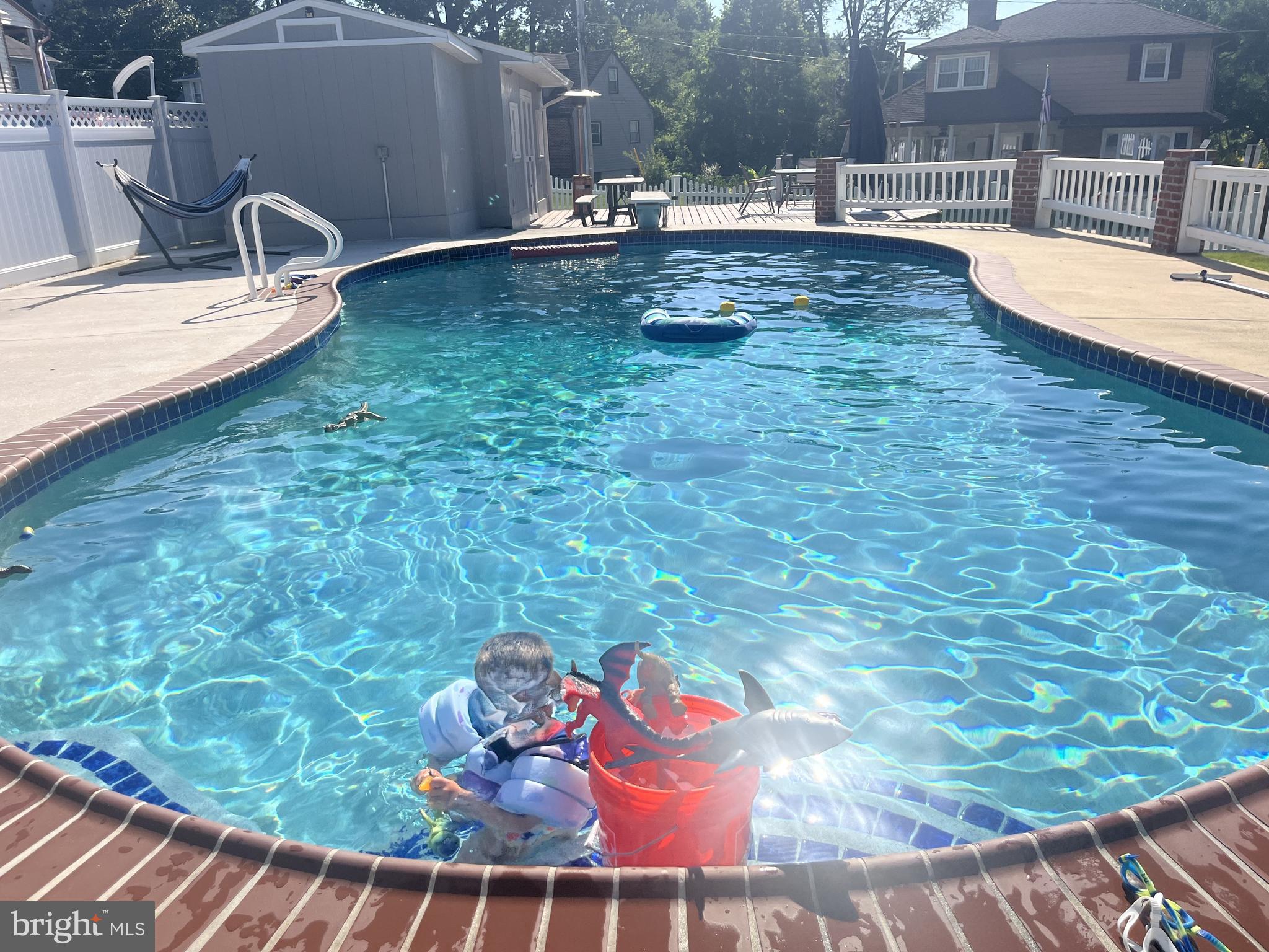 9630 10th Avenue Baltimore, MD 21234 - Photo 33 of 35 a view of a swimming pool with a yard