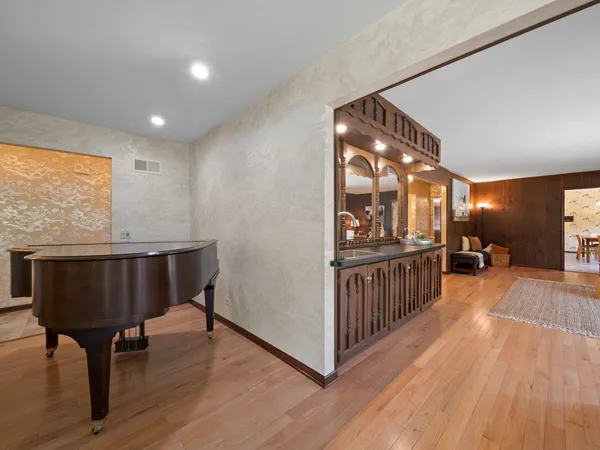 a view of a room with furniture and wooden floor