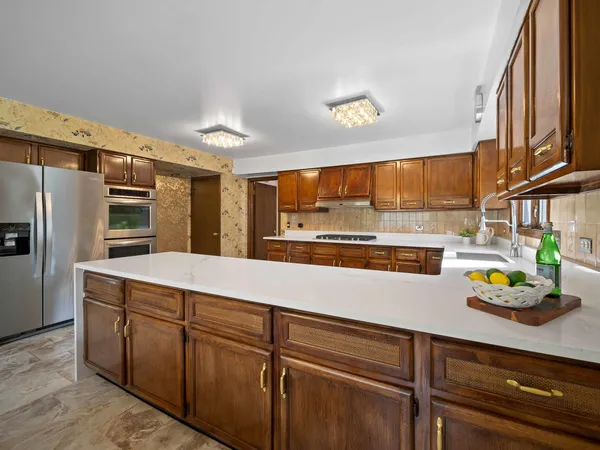 a kitchen with stainless steel appliances a sink and cabinets