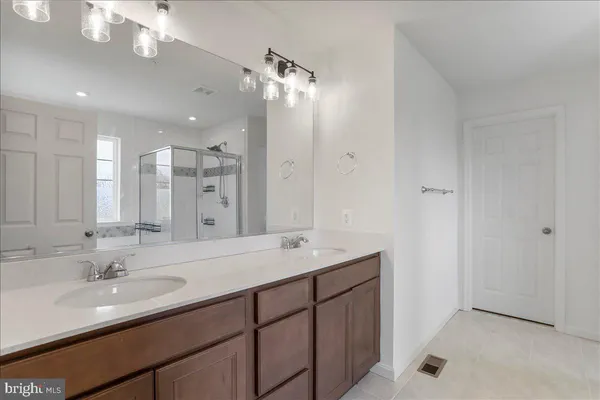 a bathroom with a double vanity sink and a mirror