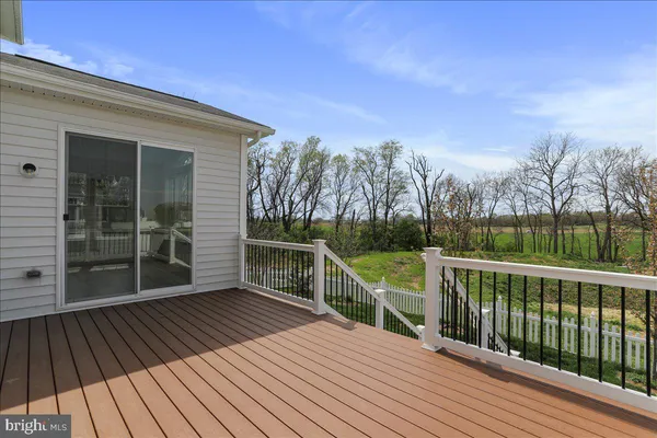 a view of a house with wooden floor next to a yard