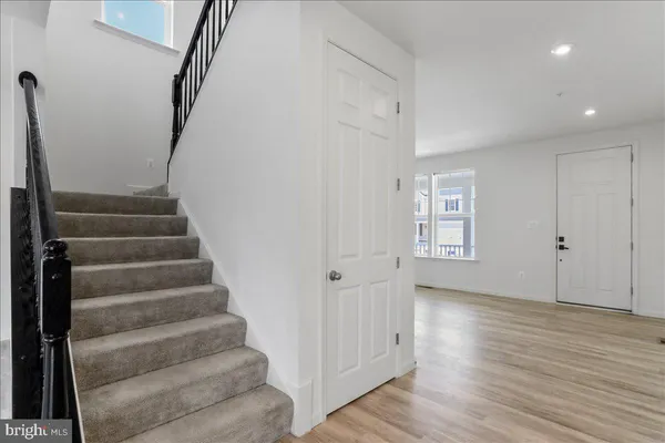 a view of an entryway with wooden floor