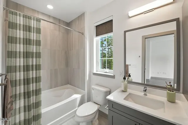 a living room with patio furniture and a large window