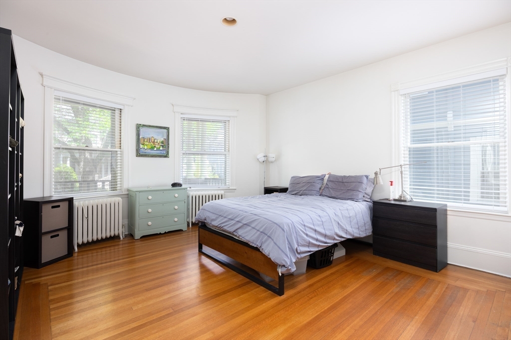 51 Naples Road Brookline, MA 02446 - Photo 14 of 16 a spacious bedroom with a bed and a large window