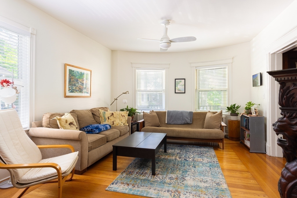 51 Naples Road Brookline, MA 02446 - Photo 16 of 16 a living room with furniture a flat screen tv and a window